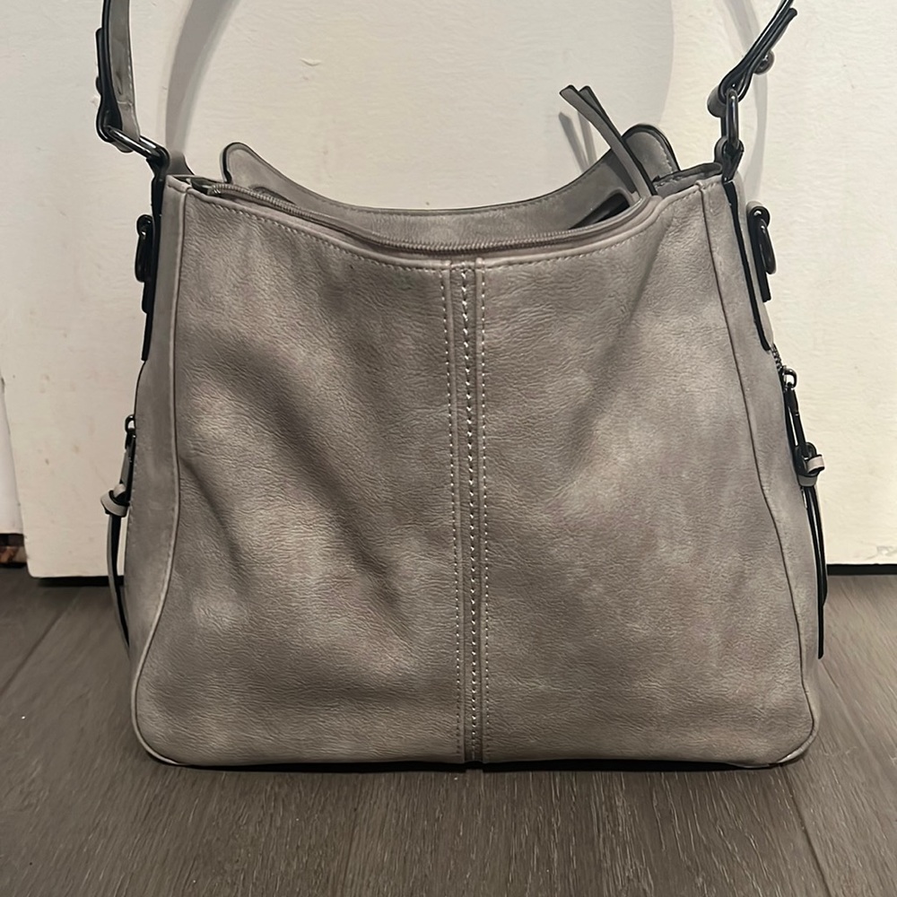 Silver, grey, slouch shoulder bag with 3 zipper compartments.